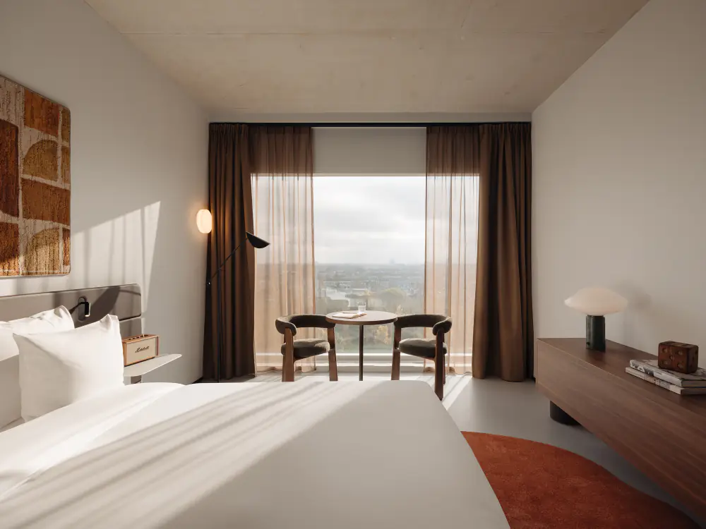 Een hotelkamer met een bed en een raam op het Oosterpark